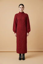 Model wearing the burgundy Maia Longo long-sleeve cable-knit maxi dress with a mock neck and ribbed cuffs