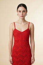 Model wearing the red Candy dress with spaghetti straps and a fitted chevron knit pattern