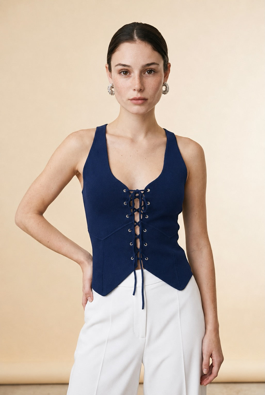 Casa Maly Navy Corset Top - Sleeveless navy knit top with lace-up front detail and curved hem