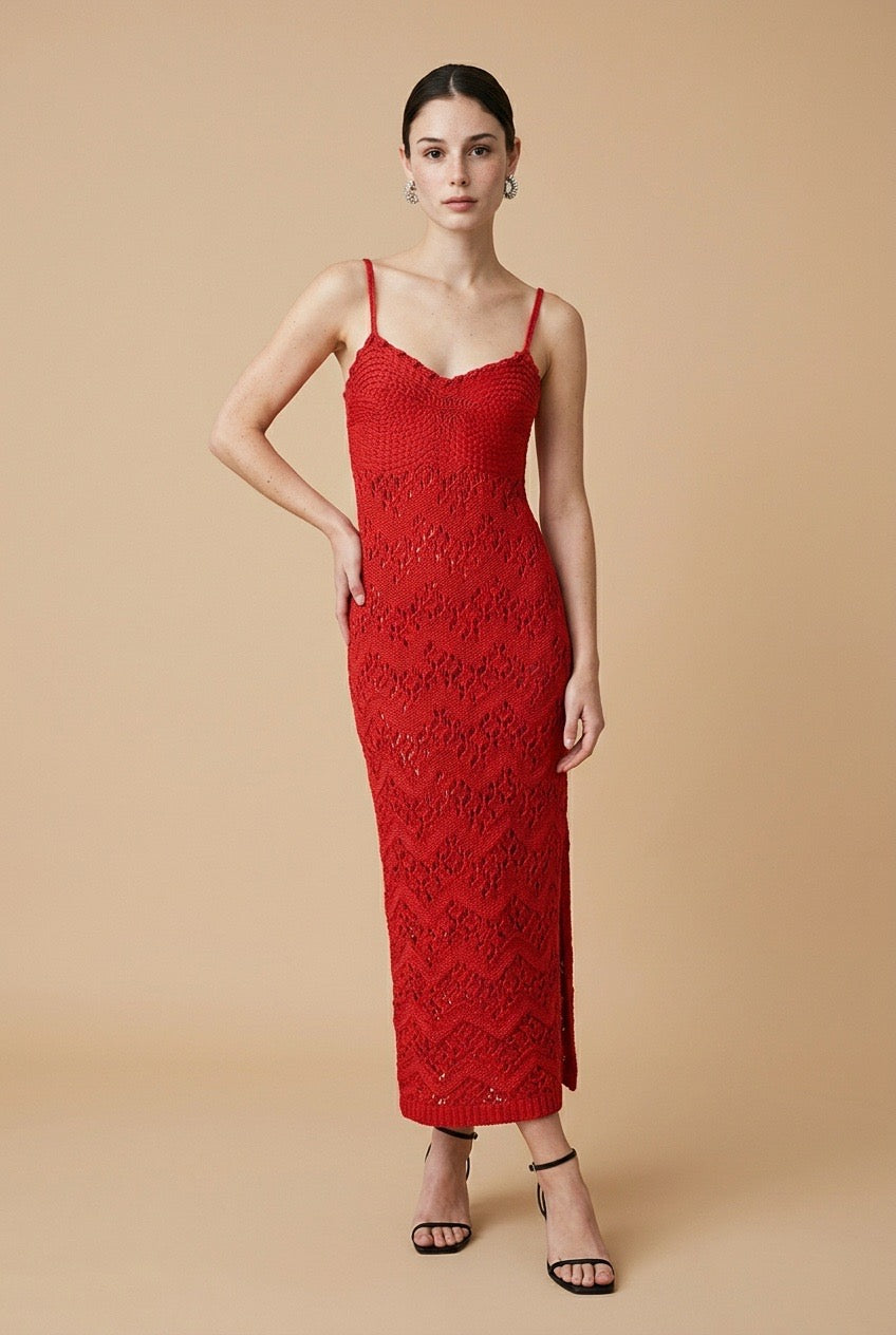 Model wearing the red Candy dress with spaghetti straps and a fitted chevron knit pattern
