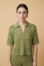 A woman wearing the Set Positano open-knit two-piece set in olive green, featuring a collared polo top and matching wide-leg trousers.