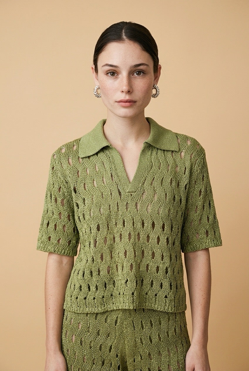 A woman wearing the Set Positano open-knit two-piece set in olive green, featuring a collared polo top and matching wide-leg trousers.