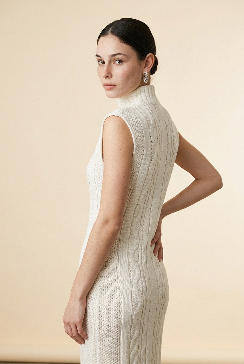 Maia sleeveless dress in off white featuring a delicate textured pattern, high neckline, and flowy silhouette