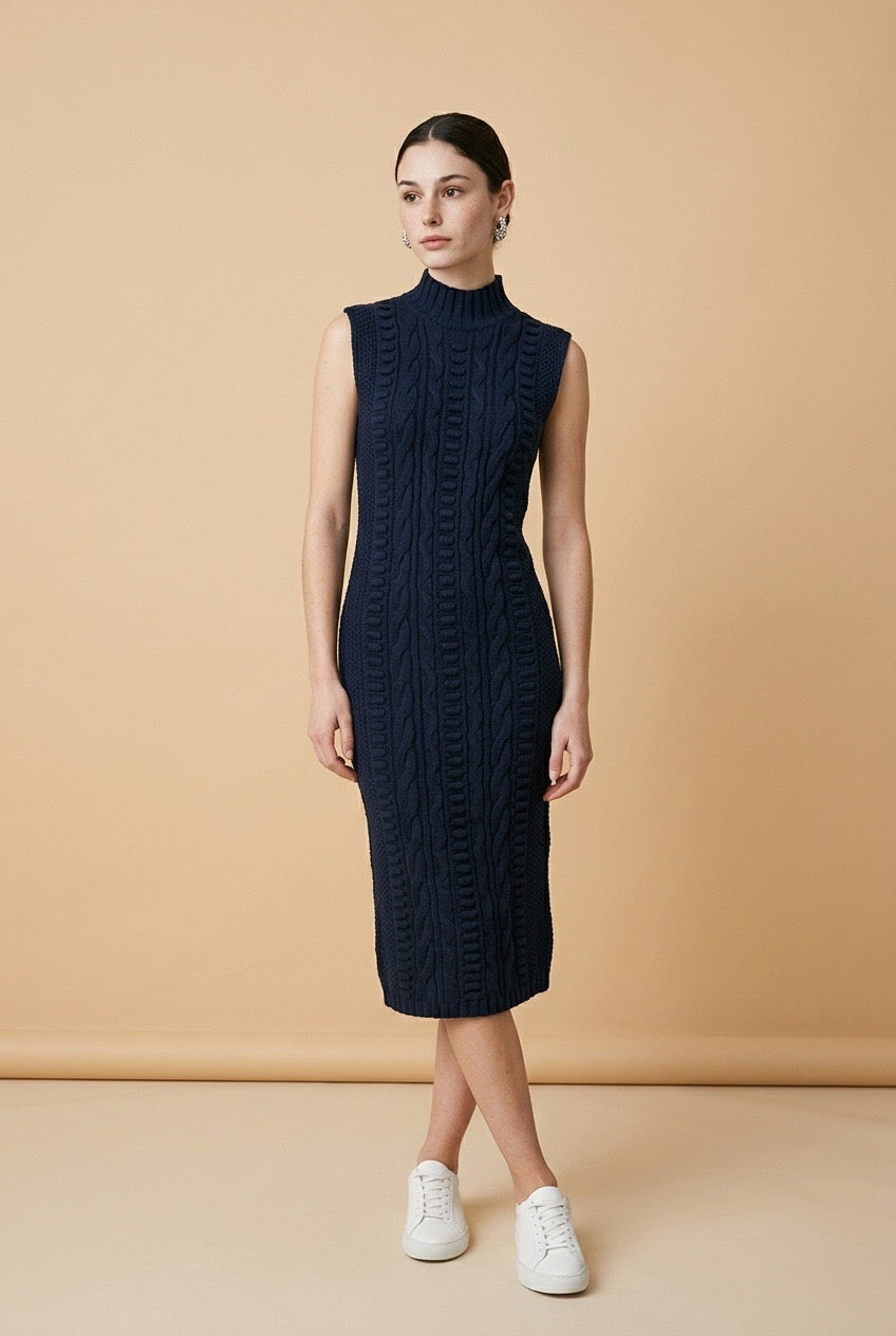 Maia sleeveless dress in navy blue featuring a delicate textured pattern, high neckline, and elegant flowy silhouette
