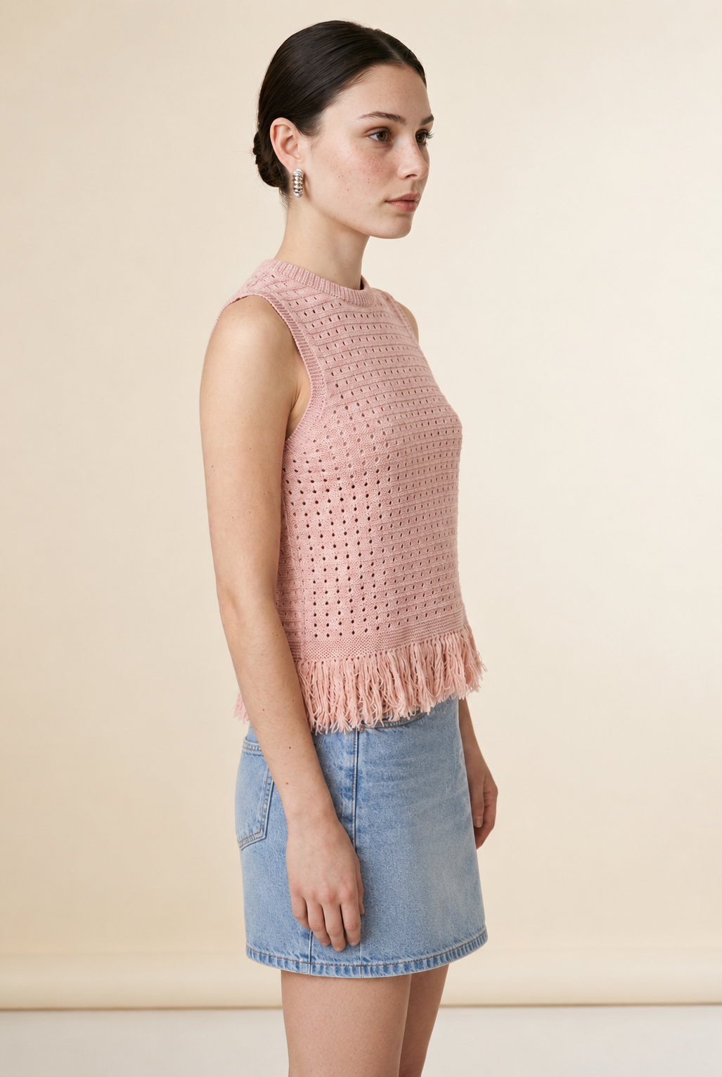Nerano sleeveless knit top in pink featuring a crew neck, open-knit texture, and fringe hem trim