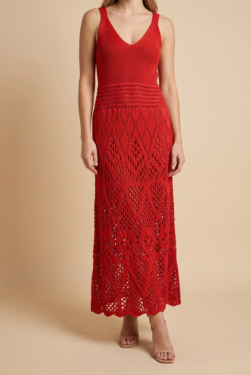 Model wearing the red Serena dress, a sleeveless V-neck knit maxi dress with a detailed lattice crochet skirt