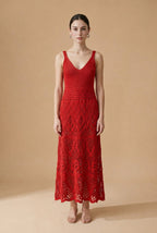 Model wearing the red Serena dress, a sleeveless V-neck knit maxi dress with a detailed lattice crochet skirt